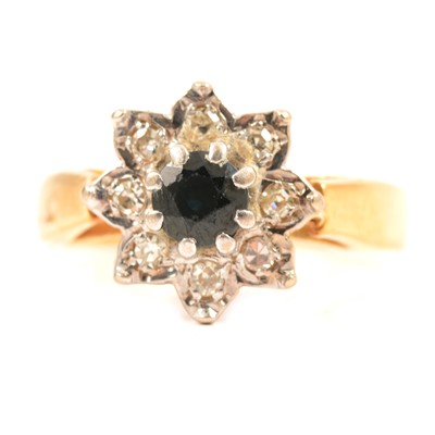 Lot 51 - A sapphire and diamond cluster ring.