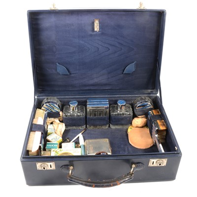 Lot 381 - A navy leather toilet case with Art Deco style bottles and jars.
