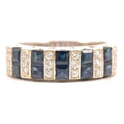Lot 57 - A sapphire and diamond half hoop ring.