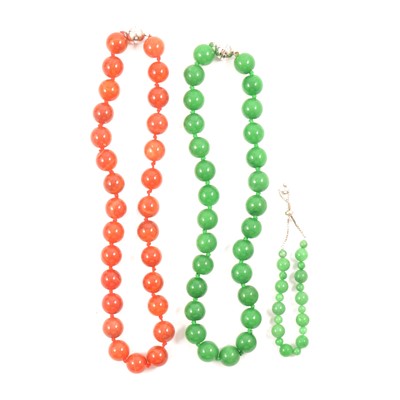 Lot 341 - A jadeite bead necklace, a cornelian bead necklace, and a jadeite bead bracelet.