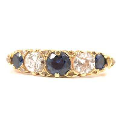 Lot 55 - A sapphire and diamond five stone half hoop ring.