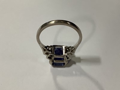 Lot 45 - A sapphire ring with two baguette cut diamonds in each shoulder.