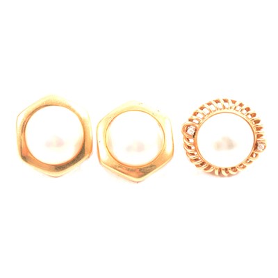 Lot 254 - A pair of gold earclips and a single earclip.
