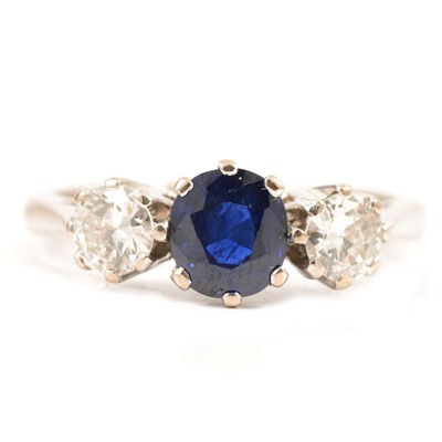 Lot 44 - A sapphire and diamond three stone ring.
