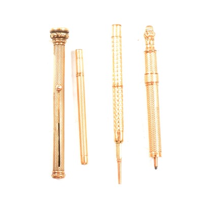 Lot 350B - Two yellow metal combination retractable pens and pencils, and two yellow metal propelling pencils.