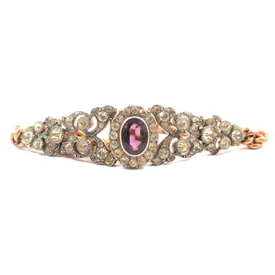 Lot 337 - A purple and clear paste bracelet with yellow metal curb links.