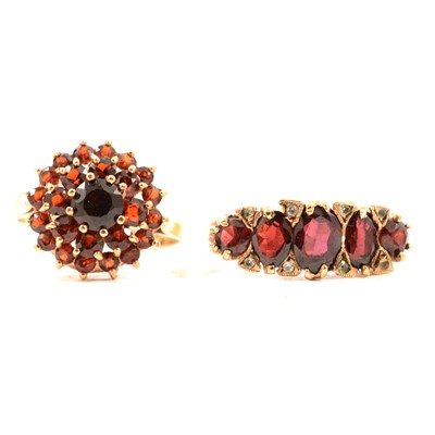 Lot 79 - Two 9 carat yellow gold garnet dress rings.