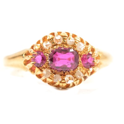 Lot 72 - A diamond and untested pink stone cluster ring.