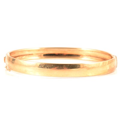 Lot 330 - A 9 carat yellow gold half hinged bangle.