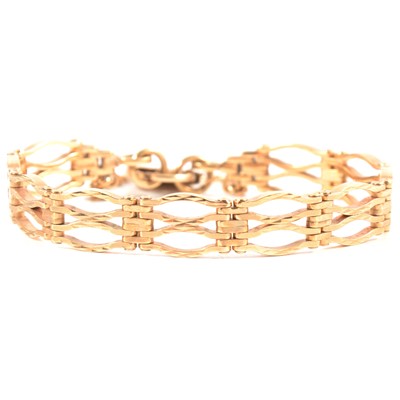 Lot 333 - A 9 carat yellow gold four bar textured gate link bracelet.