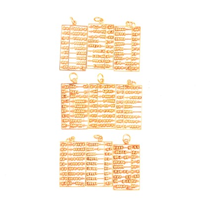 Lot 316 - Nine yellow metal abacus pendants.