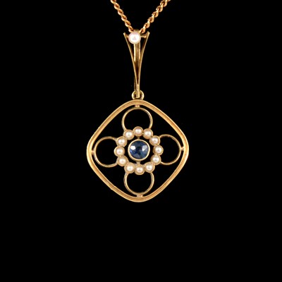 Lot 301 - A sapphire and seed pearl pendant on a yellow metal chain.