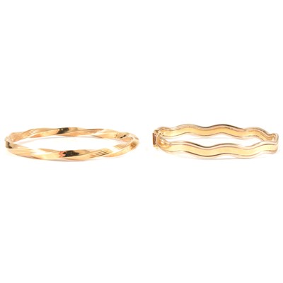 Lot 328 - Two modern 9 carat yellow gold half hinged bangles.