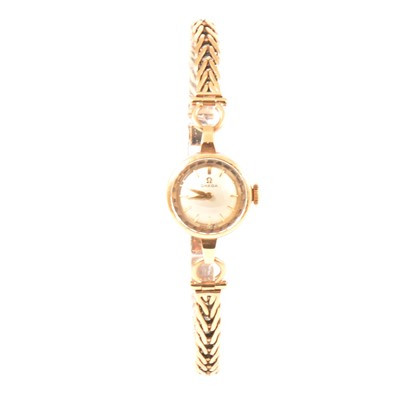 Lot 391 - Omega - a lady's 9 carat yellow gold bracelet watch.