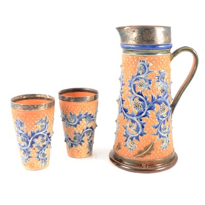 Lot 36 - George Tinworth for Doulton Lambeth, a three piece silver mounted Seaweed lemonade set, 1877