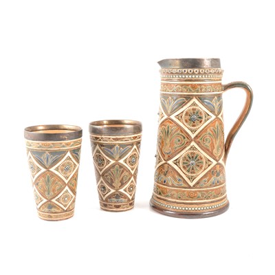 Lot 35 - Elizabeth Fisher for Doulton Lambeth, a three piece silver mounted lemonade set, 1878
