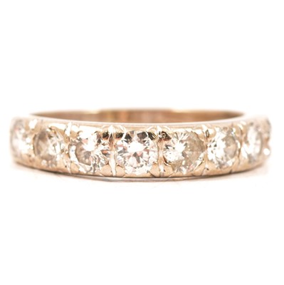 Lot 16 - A diamond half eternity ring.