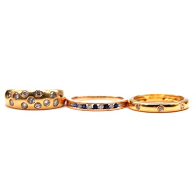 Lot 40 - Three modern diamond half hoop rings.