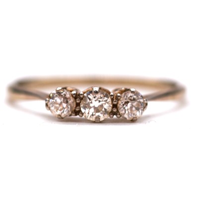 Lot 18 - A diamond three stone ring and seven loose diamonds.
