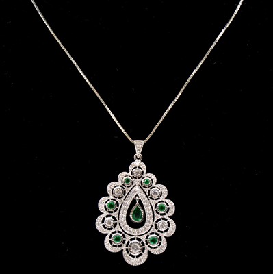 Lot 207 - A diamond and emerald pendant and chain.