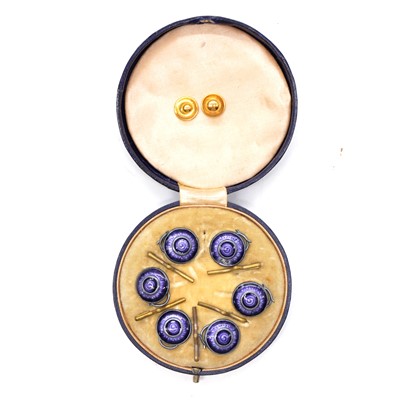 Lot 264 - A case set of six purple enamel dress studs and two gold studs.