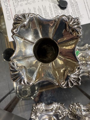 Lot 33 - Set of four George II cast silver candlesticks
