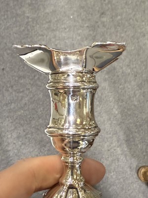 Lot 33 - Set of four George II cast silver candlesticks