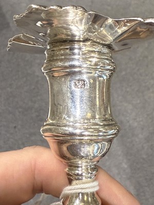 Lot 33 - Set of four George II cast silver candlesticks