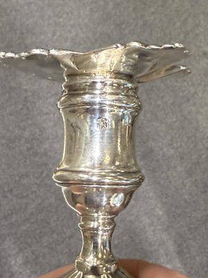 Lot 33 - Set of four George II cast silver candlesticks
