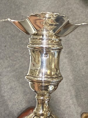 Lot 33 - Set of four George II cast silver candlesticks