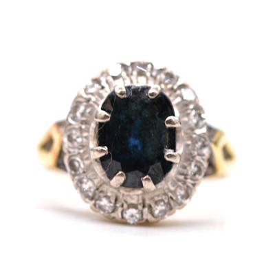 Lot 61 - A sapphire and diamond cluster ring.