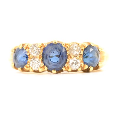 Lot 20 - A sapphire and diamond half hoop ring.