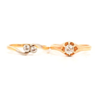Lot 80 - A diamond solitaire ring and a diamond two stone crossover ring.