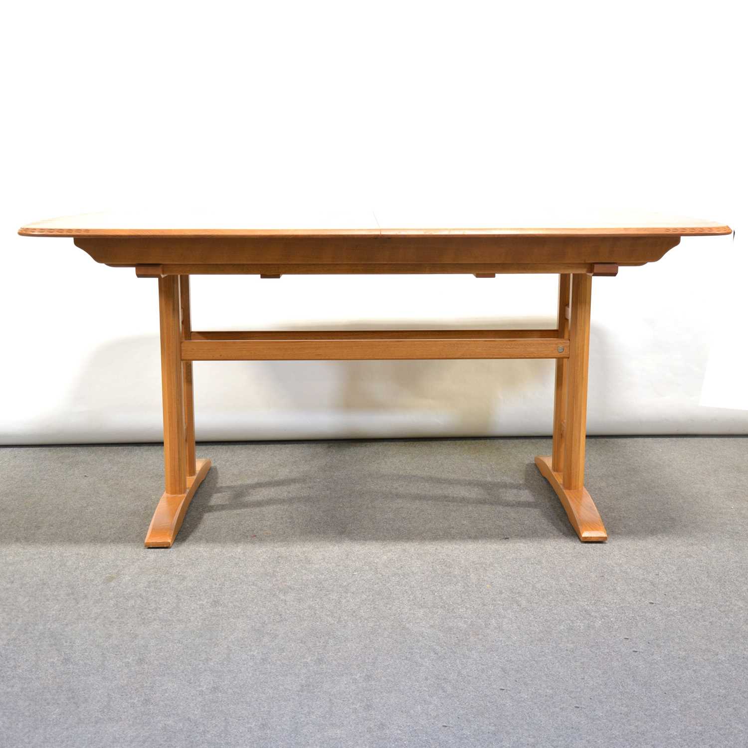 Lot 24 - A 'Burford' extending dining table with six Swan-back chairs, by Ercol