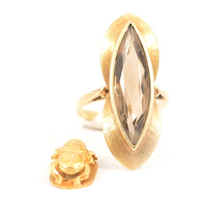 Lot 75 - A smoky dress quartz ring and scarab charm.