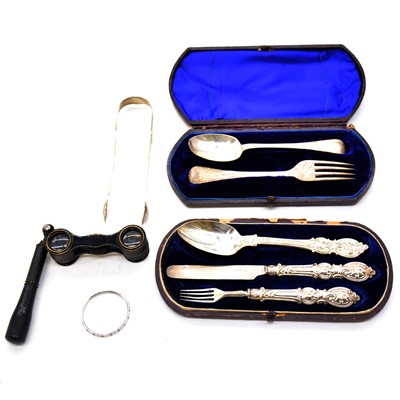 Lot 227 - Two silver christening sets, silver sugar tongs, opera glasses and child's bangle.