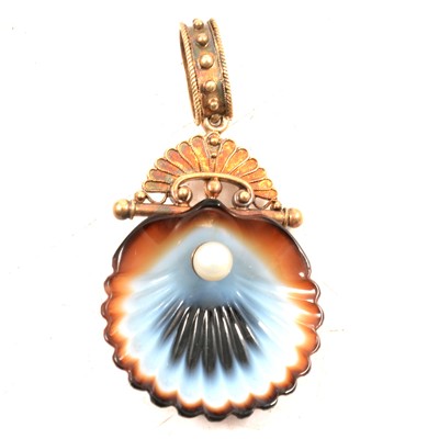 Lot 186 - A carved banded agate and cultured pearl shell pendant.