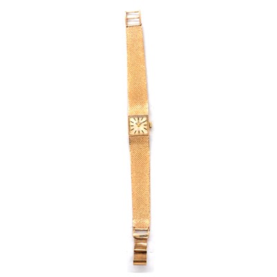 Lot 415 - Tissot - a lady's 9 carat yellow gold manual wind wristwatch.