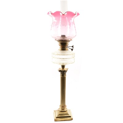 Lot 489 - Victorian brass oil lamp, cranberry shade