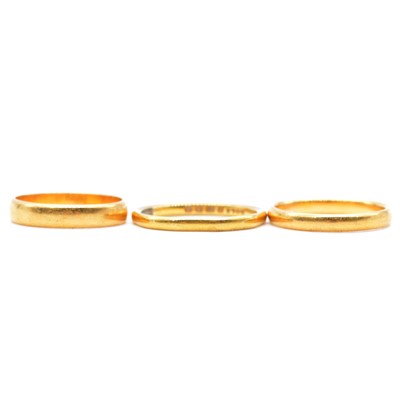 Lot 105 - Three 22 carat yellow gold wedding bands.