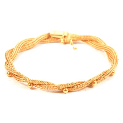 Lot 251 - A yellow metal two strand woven bracelet.