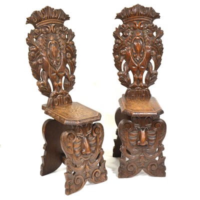 Lot 415 - Pair of late 19th Century European oak hall chairs