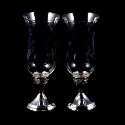 Lot 340 - Pair of glass hurricane lamps with white metal bases, and twelve glass and white metal coasters.