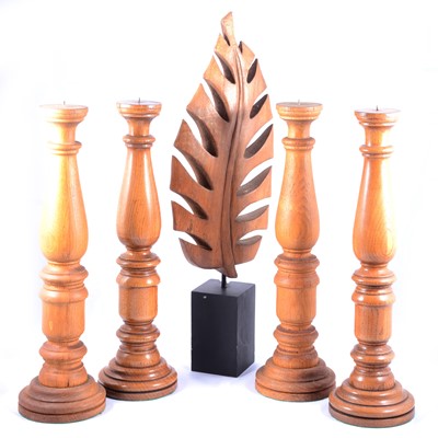 Lot 484 - Set of four oak candlestands, and a leaf sculpture