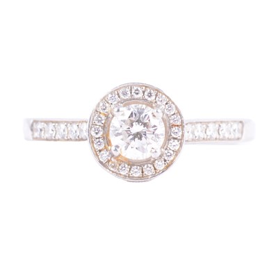 Lot 61 - A diamond cluster ring with diamond set shoulders.