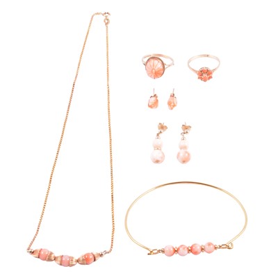 Lot 319 - Two coral rings, coral necklace, coral bangle and two pairs of coral earrings.