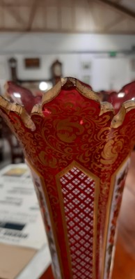 Lot 136 - Bohemian overlaid ruby glass flute and enamelled amber glass flask.