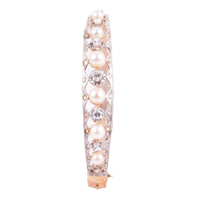 Lot 188 - A Victorian style half hinged bangle with synthetic white stones.